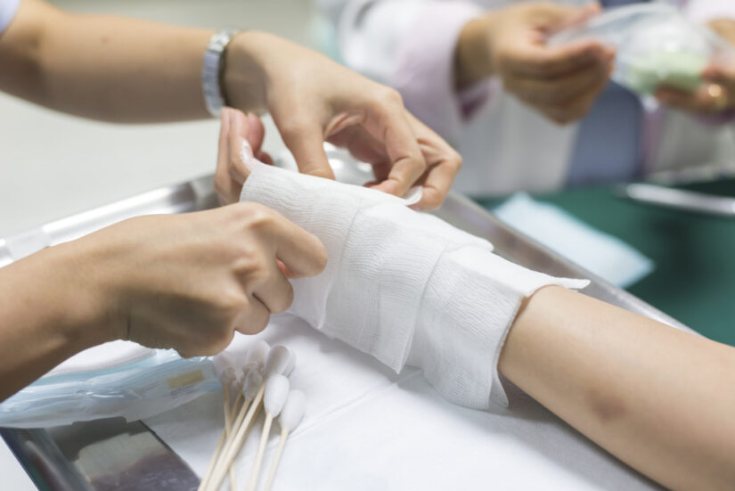 Photo of a Nurse Dressing an Injured Hand